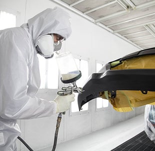 Collision Center Technician Painting a Vehicle | Longo Toyota of Prosper in Prosper TX