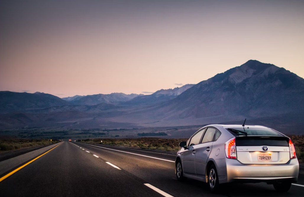 a toyota prius driving on a mountain road