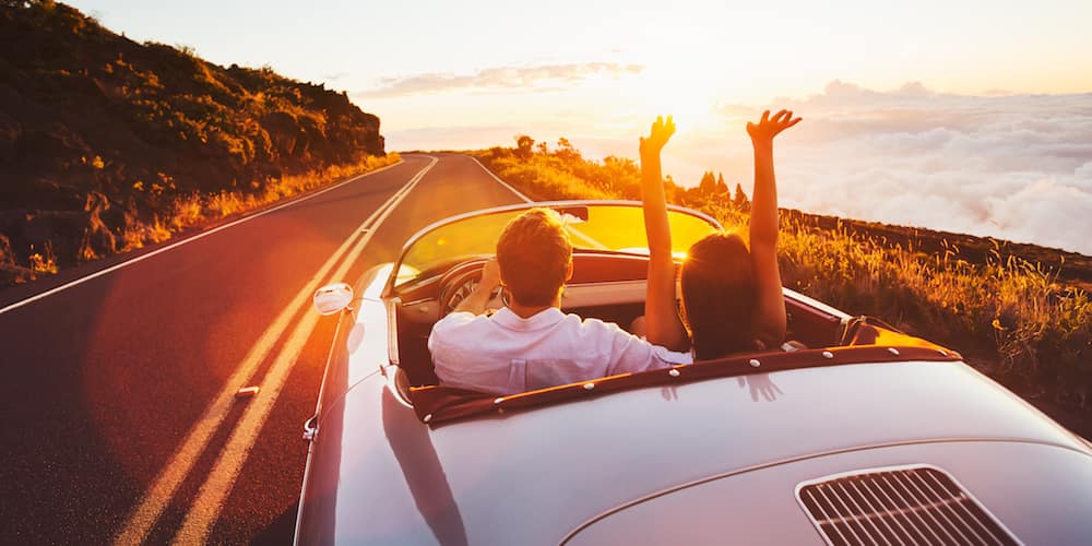 Couple Driving Towards Sunset in Convertible | Longo Toyota of Prosper in Prosper TX