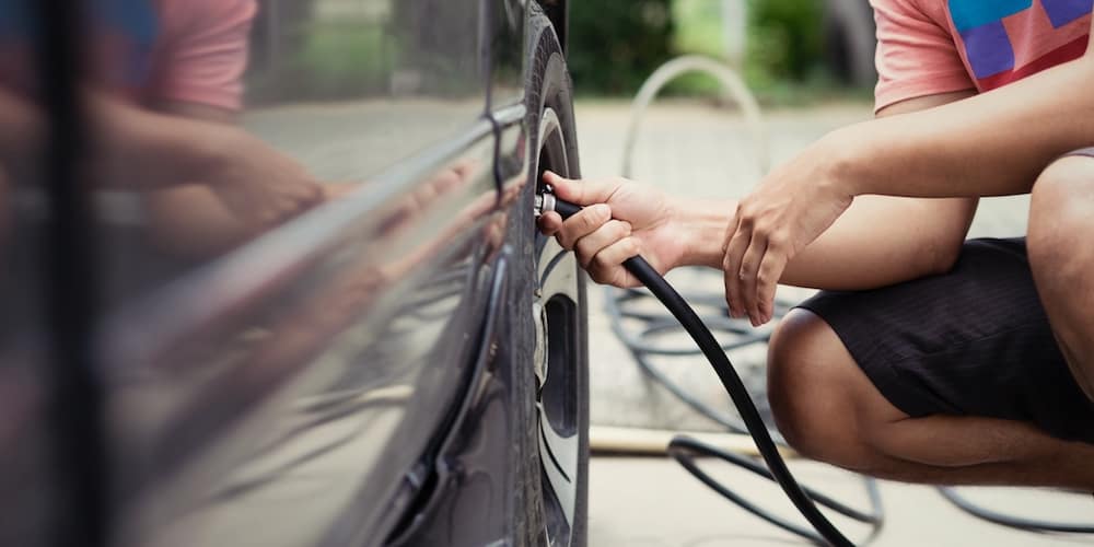 Man Filling Up Tire at Home | Longo Toyota of Prosper in Prosper TX